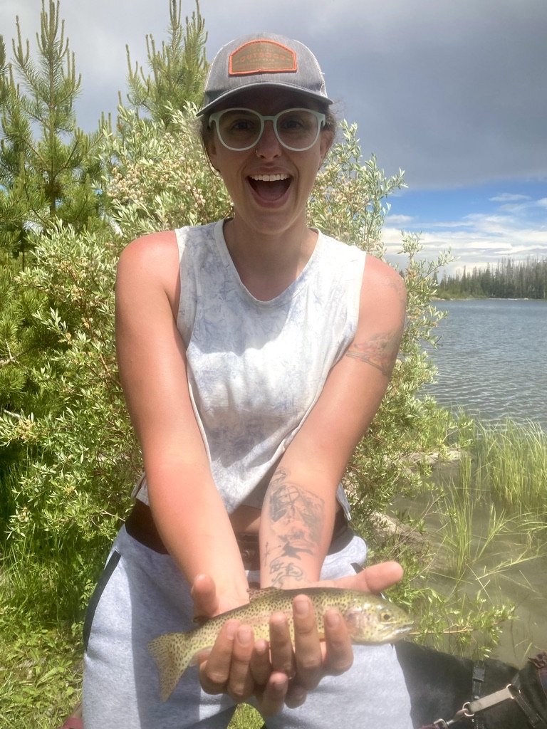Crysahna holding a trout she caught
