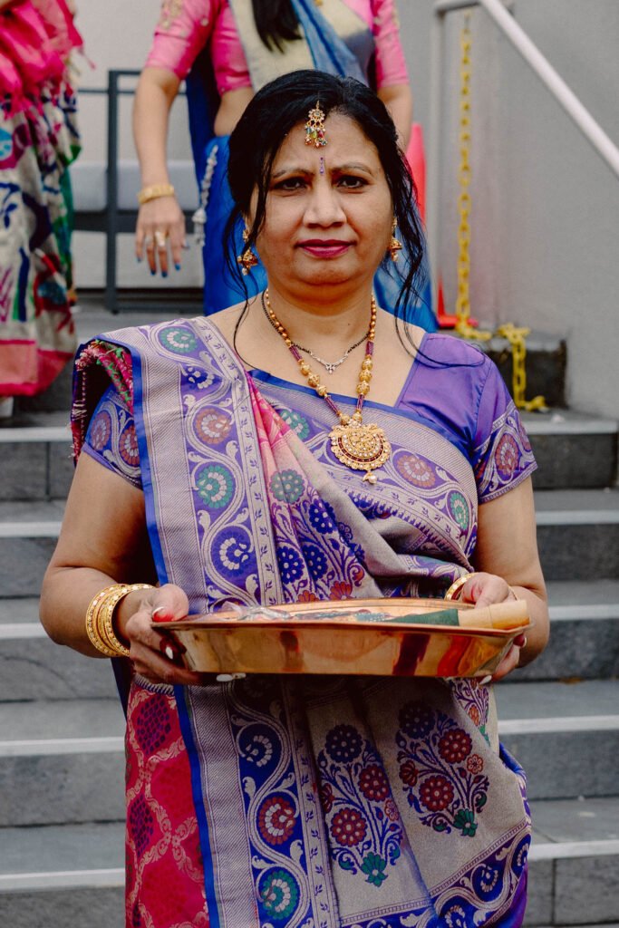 Woman holding objects for Sangeet