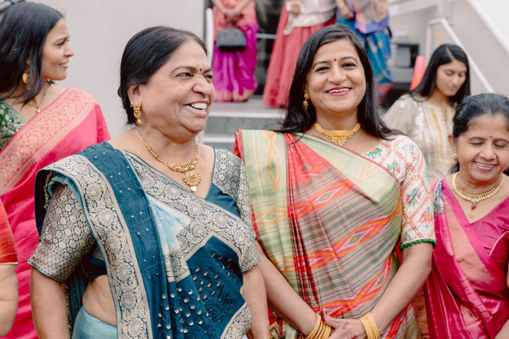 Women laughing and dancing during Sangeet