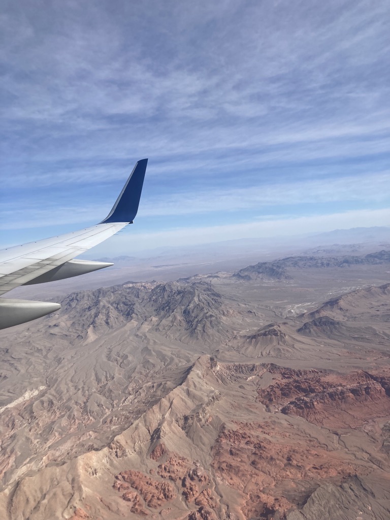 Photo of plane over a mountain dessert / Las Vegas