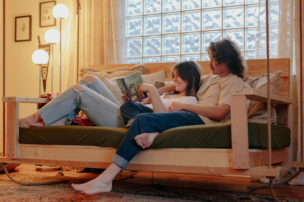 unique couple reading books in their living room for a photoshoot 