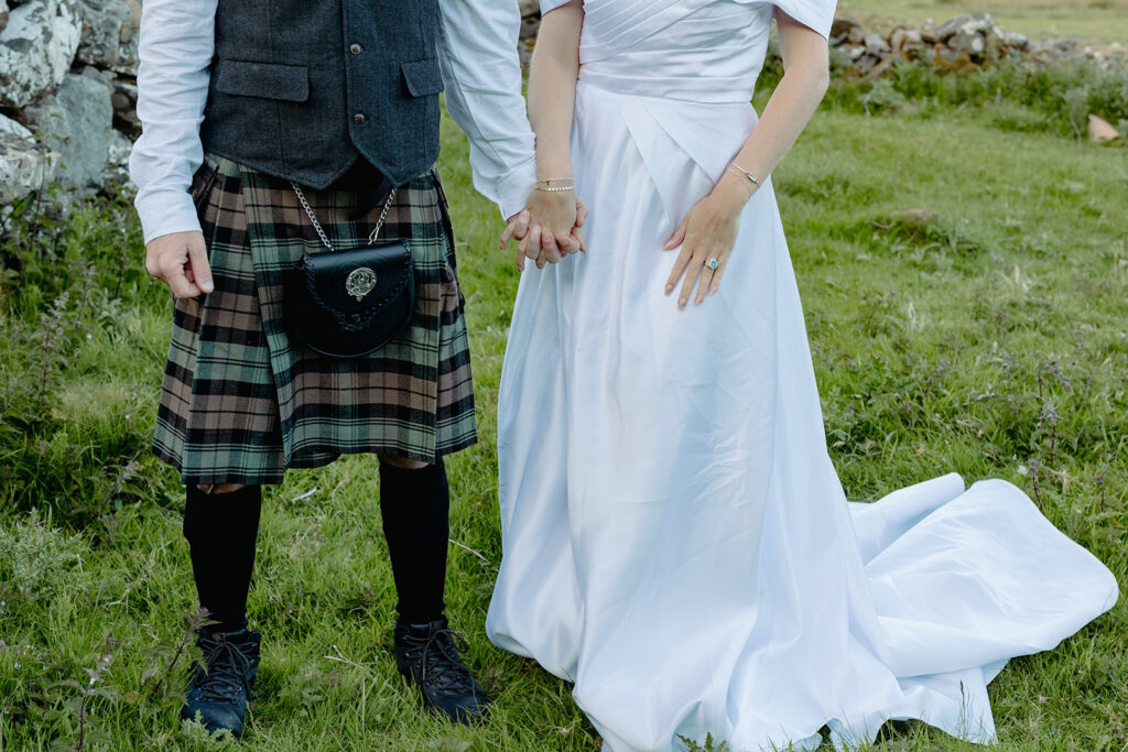 Lower half of a bride and groom in traditional Scottish attire